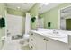 Bathroom with updated fixtures and ample lighting above the vanity and shower with tub at 2912 Fiddlers Bnd, Palmetto, FL 34221