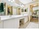 Large bathroom featuring double sinks, white cabinets, and access to the bedroom at 2912 Fiddlers Bnd, Palmetto, FL 34221