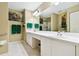 Bathroom featuring double sinks, white countertop, and large mirror at 2912 Fiddlers Bnd, Palmetto, FL 34221