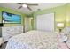 Comfortable bedroom featuring a ceiling fan, closet, and a flat-screen television for relaxing evenings at 2912 Fiddlers Bnd, Palmetto, FL 34221