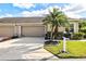 Lovely single story home with a well-kept lawn, mature palm tree, and a convenient two-car garage at 2912 Fiddlers Bnd, Palmetto, FL 34221