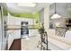 Inviting kitchen with modern appliances, granite counters, white cabinets, and adjacent dining area at 2912 Fiddlers Bnd, Palmetto, FL 34221