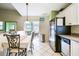 Eat-in kitchen offers stainless steel appliances, white cabinets, tile flooring and sliding glass doors to lanai at 2912 Fiddlers Bnd, Palmetto, FL 34221