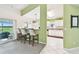 Open-concept kitchen features a breakfast bar with seating, white cabinetry, and a seamless flow to outdoor spaces at 2912 Fiddlers Bnd, Palmetto, FL 34221
