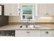 Kitchen sink area with granite countertops, bright natural light, and neutral color scheme at 2912 Fiddlers Bnd, Palmetto, FL 34221