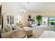 Bright living room with carpet, opening to lanai, and stylish furnishings at 2912 Fiddlers Bnd, Palmetto, FL 34221