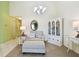 Bright living room with beige carpet, white chandelier, and beige chair at 2912 Fiddlers Bnd, Palmetto, FL 34221