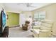 Bright living room with comfortable chairs, a television, and natural light from the window at 2912 Fiddlers Bnd, Palmetto, FL 34221