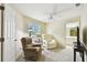 Cozy living room with comfortable seating, a reading lamp, and a view into the bathroom at 2912 Fiddlers Bnd, Palmetto, FL 34221