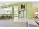 Open-concept living area with bar seating, ceramic tile flooring, and bright atmosphere at 2912 Fiddlers Bnd, Palmetto, FL 34221