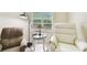 Comfortable chairs and a reading lamp are featured in this bright living room at 2912 Fiddlers Bnd, Palmetto, FL 34221