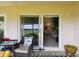 Relaxing screened patio with view of golf course, comfortable seating, and sliding glass doors to the living area at 2912 Fiddlers Bnd, Palmetto, FL 34221