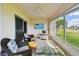 Enclosed patio offers seating with a ceiling fan, flat screen tv, and stunning views of the landscape at 2912 Fiddlers Bnd, Palmetto, FL 34221
