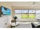 Bright patio with a view of green golf course and a mounted flat screen television at 2912 Fiddlers Bnd, Palmetto, FL 34221
