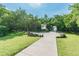 Scenic paved walkway leads through a park, surrounded by lush greenery at 2912 Fiddlers Bnd, Palmetto, FL 34221