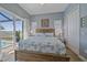 Bright bedroom features a plush bed, a view of the pool, and shuttered windows for optimal light control at 29527 Leah Rd, Punta Gorda, FL 33982