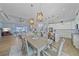 Spacious dining area connected to the living room and kitchen, featuring modern lighting and stylish decor at 29527 Leah Rd, Punta Gorda, FL 33982