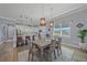 Elegant dining area showcasing a table for six with modern light fixtures and seamless access to the kitchen for convenient serving at 29527 Leah Rd, Punta Gorda, FL 33982