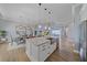 Open kitchen boasts granite counters, stainless appliances, island, and pendant lighting at 29527 Leah Rd, Punta Gorda, FL 33982