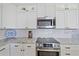 Well appointed kitchen with stainless steel appliances, granite countertops, and white subway tile backsplash at 29527 Leah Rd, Punta Gorda, FL 33982