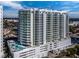 Modern high-rise building with a pool deck overlooking the city skyline, featuring sleek architecture and expansive balconies at 301 Quay Commons # 1708, Sarasota, FL 34236