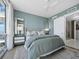 This bedroom boasts natural light, neutral toned walls, and opens to a bathroom with tile floors at 301 Quay Commons # 1708, Sarasota, FL 34236