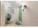 Charming home entrance with a decorative green door and a welcoming potted plant at 3328 Dartmouth Ln # 1012, Sarasota, FL 34239