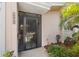 Close-up of the home's entryway, featuring a security screen and decorative address numbers at 3328 Dartmouth Ln # 1012, Sarasota, FL 34239