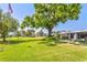 A well-maintained yard features a majestic shade tree and manicured lawn at 3328 Dartmouth Ln # 1012, Sarasota, FL 34239