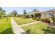 View of multiple homes and manicured landscaping along walkway in a tranquil neighborhood at 3328 Dartmouth Ln # 1012, Sarasota, FL 34239