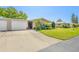 Beautiful single-story home with a lush lawn and attached two-car garage on a sunny day at 3328 Dartmouth Ln # 1012, Sarasota, FL 34239