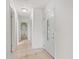 Bright hallway with tiled floors leads to a bedroom with a charming mural at 3328 Dartmouth Ln # 1012, Sarasota, FL 34239