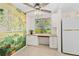 Cozy kitchen with a built-in desk area, a large window, and a charming mural wall at 3328 Dartmouth Ln # 1012, Sarasota, FL 34239