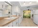 Bright kitchen features white cabinetry, modern appliances, and a beautiful decorative mural at 3328 Dartmouth Ln # 1012, Sarasota, FL 34239
