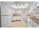 Spacious kitchen with white appliances, cabinets, and ample counter space under a bright skylight at 3328 Dartmouth Ln # 1012, Sarasota, FL 34239