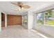 Living room featuring tiled flooring, ceiling fan, and large windows with abundant natural light at 3328 Dartmouth Ln # 1012, Sarasota, FL 34239