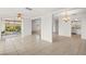 Open-concept living room with tile flooring leads to the outdoors and has a dining area with chandelier at 3328 Dartmouth Ln # 1012, Sarasota, FL 34239