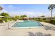 Community pool with a seating area surrounded by well-maintained landscaping and several homes at 3328 Dartmouth Ln # 1012, Sarasota, FL 34239