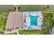 Birds eye view of a unique community pool with ample seating, palm trees, and views of the adjacent lake at 3821 Lake Bayshore Dr # H-507, Bradenton, FL 34205