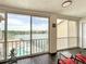 Enclosed balcony overlooking a pool and lake with sliding glass doors and a seating area at 3821 Lake Bayshore Dr # H-507, Bradenton, FL 34205