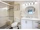 Well-lit bathroom with a glass-enclosed shower, sleek white vanity, and neutral color palette at 3821 Lake Bayshore Dr # H-507, Bradenton, FL 34205