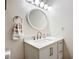 Bright bathroom featuring a round mirror, modern vanity, and neutral wall color at 3821 Lake Bayshore Dr # H-507, Bradenton, FL 34205