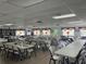 Spacious community room with tables, chairs, and decorations at 3821 Lake Bayshore Dr # H-507, Bradenton, FL 34205