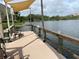 Community dock on a lake with a canopy and benches for relaxing by the water at 3821 Lake Bayshore Dr # H-507, Bradenton, FL 34205