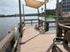 Community dock on a lake with a canopy and benches for relaxing by the water at 3821 Lake Bayshore Dr # H-507, Bradenton, FL 34205