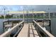 Community dock on a lake with a canopy and benches for relaxing by the water at 3821 Lake Bayshore Dr # H-507, Bradenton, FL 34205