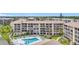Exterior of condo with multiple screened-in lanais overlooking the community pool at 3821 Lake Bayshore Dr # H-507, Bradenton, FL 34205