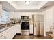 Bright kitchen with white cabinetry and modern stainless steel appliances, designed for convenient meal preparation at 3821 Lake Bayshore Dr # H-507, Bradenton, FL 34205