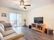 Cozy living room with a ceiling fan, access to the balcony, and water views at 3821 Lake Bayshore Dr # H-507, Bradenton, FL 34205