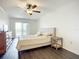 Relaxing bedroom with balcony access, natural light, and wood-look flooring at 3821 Lake Bayshore Dr # H-507, Bradenton, FL 34205